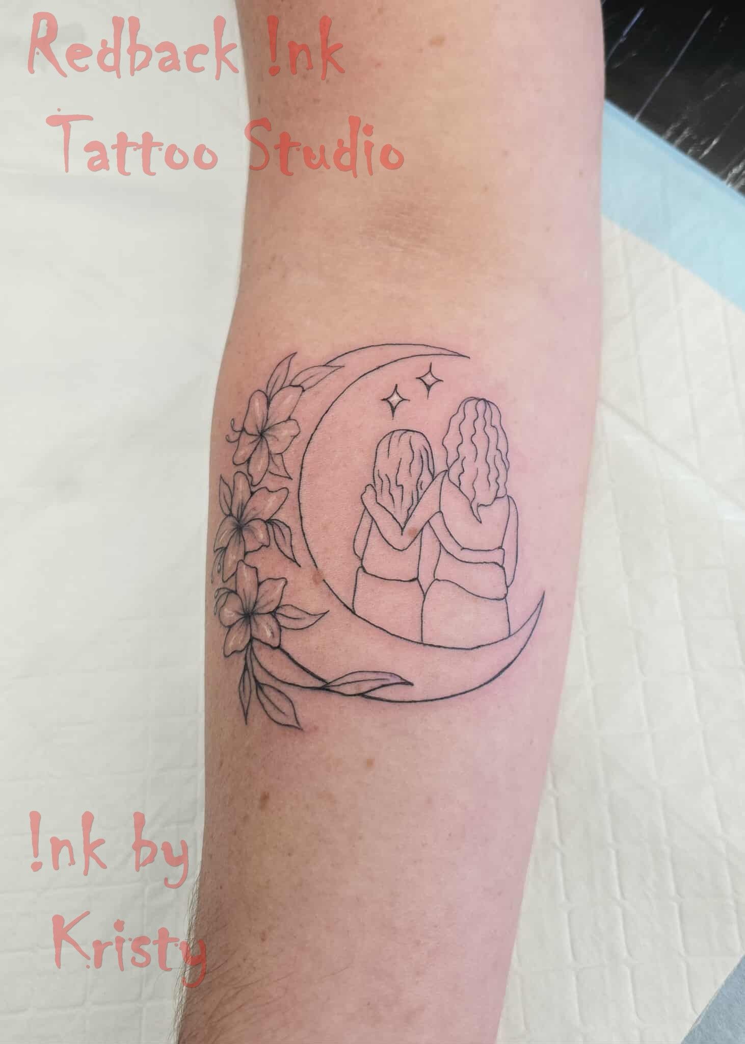 Black line art tattoo of two figures, a crescent moon, stars, and flowers on an arm — Redback !nk Tattoo Studio in Kawana, QLD