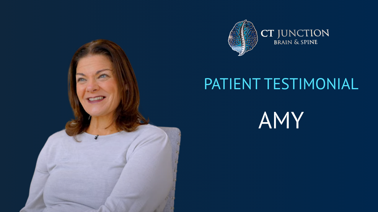 Amy, a patient, smiles in a testimonial video for CT Junction Brain Clinic. Blue background.