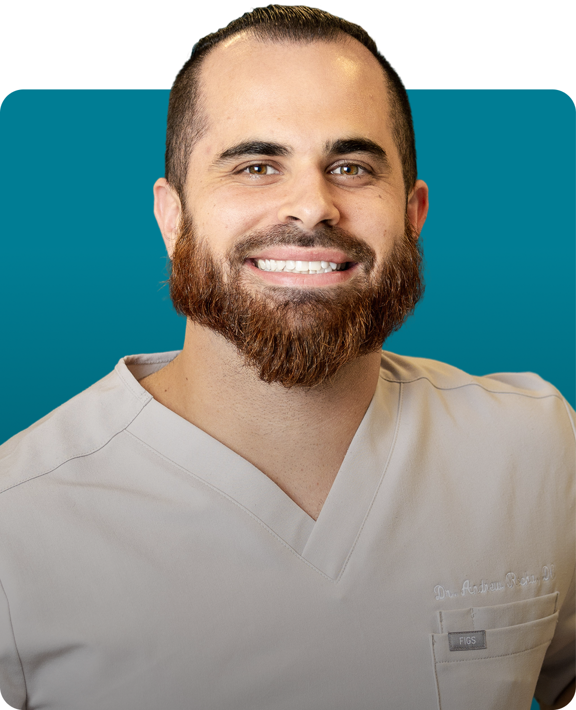 Dr. Andrew Rocha smiling, wearing light-colored scrubs. Teal background.