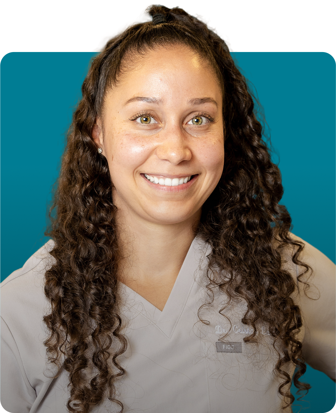 Dr. Cristal Laboy smiles, wearing a light gray scrubs, against a blue-green background.