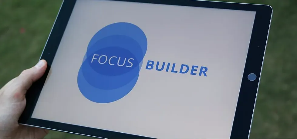 Woman checking the head and shoulders of an older man; they are inside a clinic.