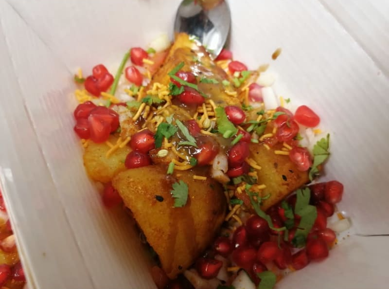 A close up of a plate of food with a spoon in it.