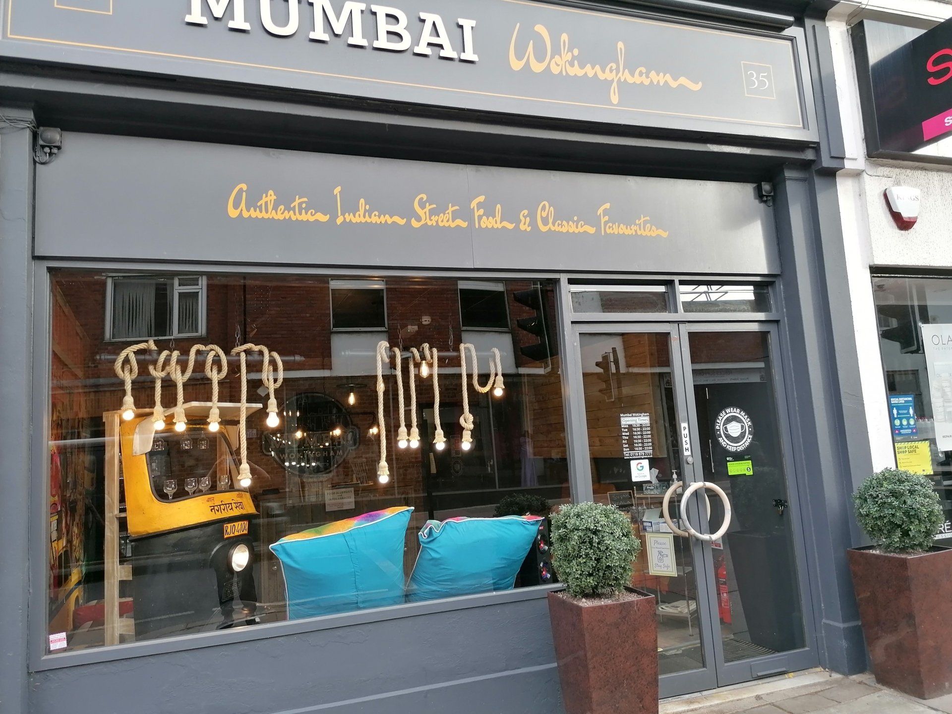 A store front with a sign that says ' mumbai ' on it