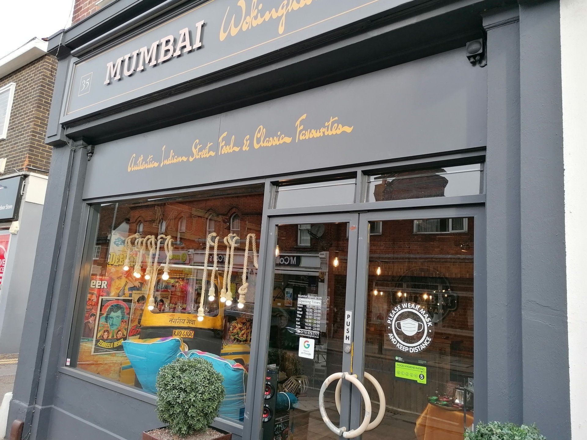 A store front with a sign that says ' mumbai ' on it.