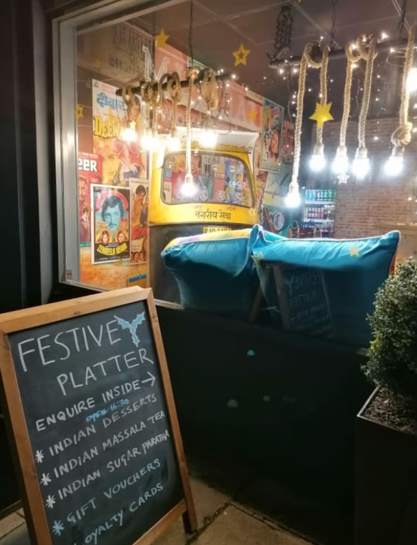 A sign that says festivey platter is in front of a restaurant.