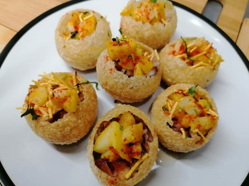 A plate of food with potatoes and cheese on it.