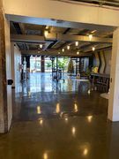 Open, modern space with a polished concrete floor, lots of natural light, and exposed ceiling fixtures.