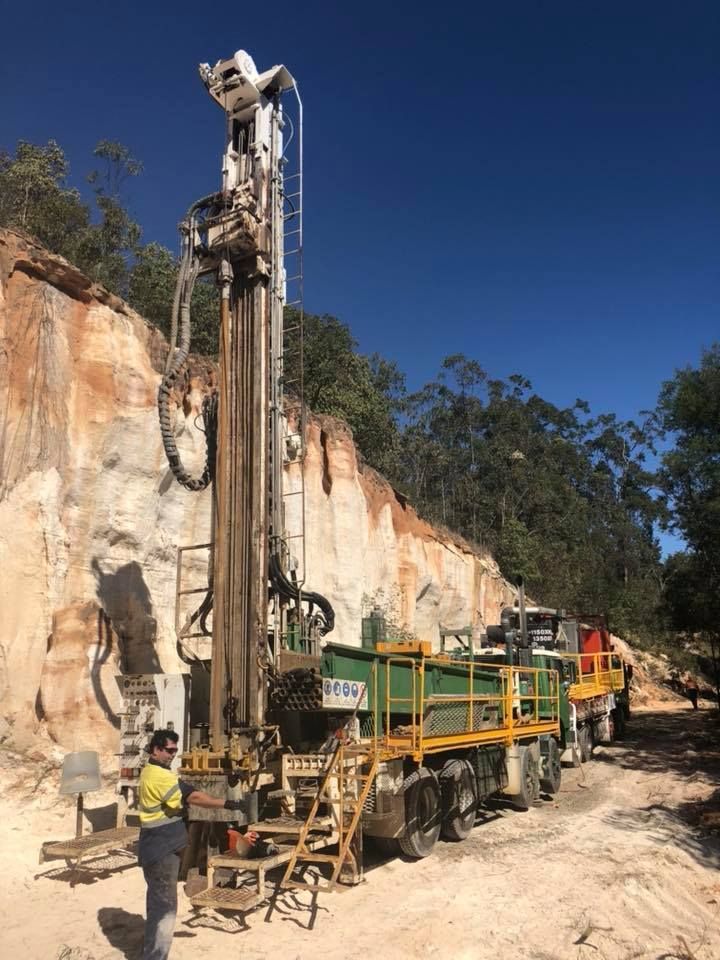 A Machine is Drilling a Hole in the Ground in the Middle of a Quarry — Kowaltzke Drilling Services in Gatton, QLD 