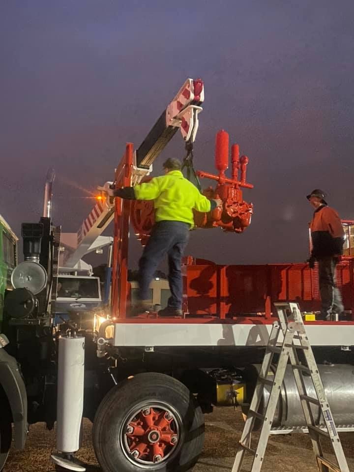 Men Working in Back Of A Drill Truck — Kowaltzke Drilling Services in Gatton, QLD