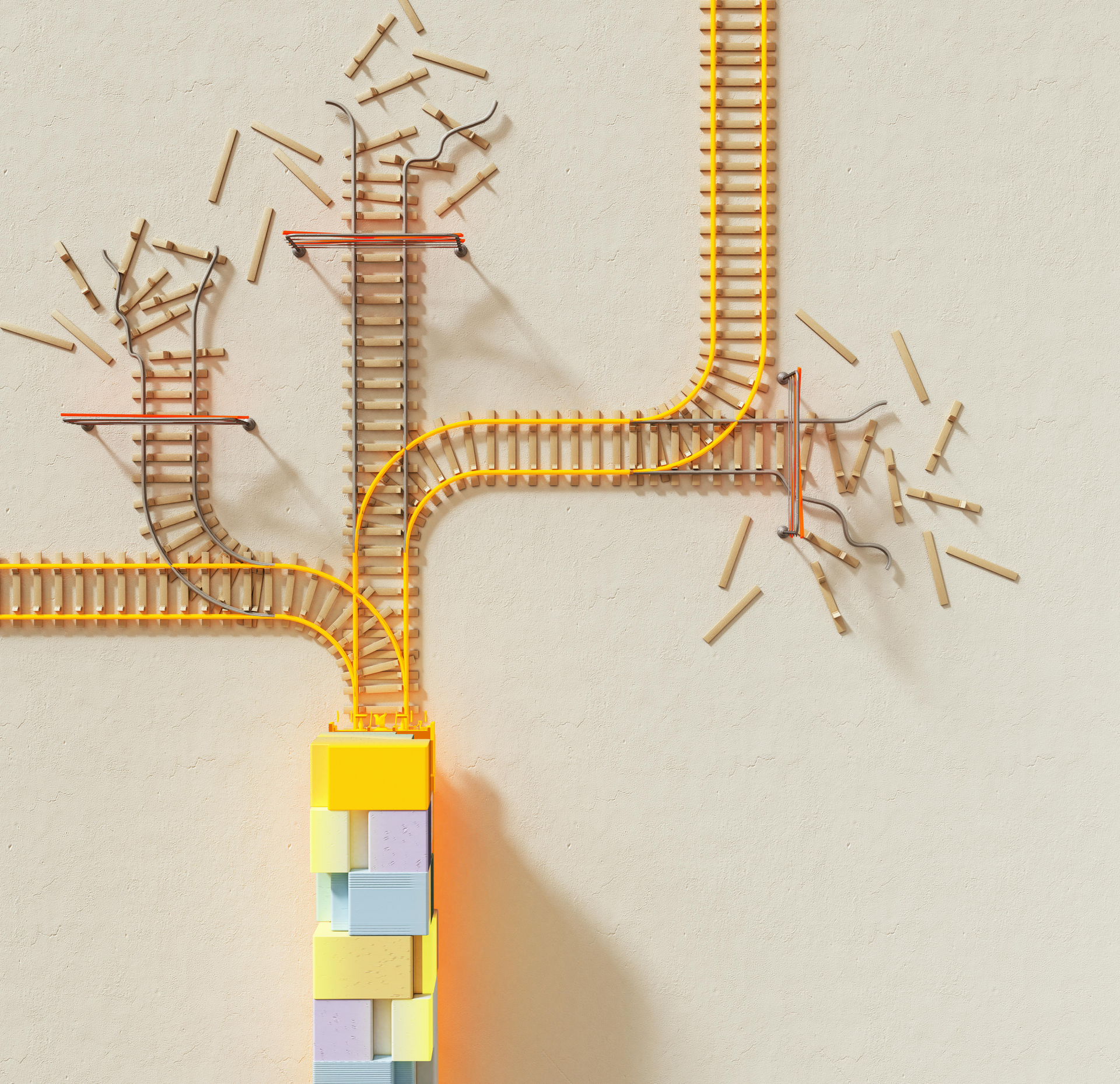 Toy train tracks branching out from a yellow and colorful tower on a beige surface.