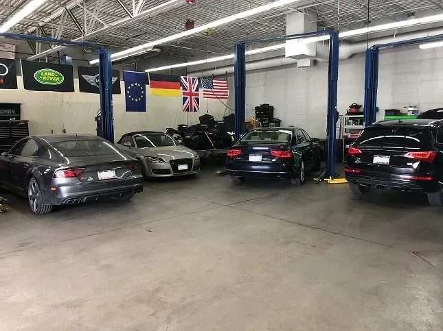 Various cars parked around inside our garage | AutoImports of Denver