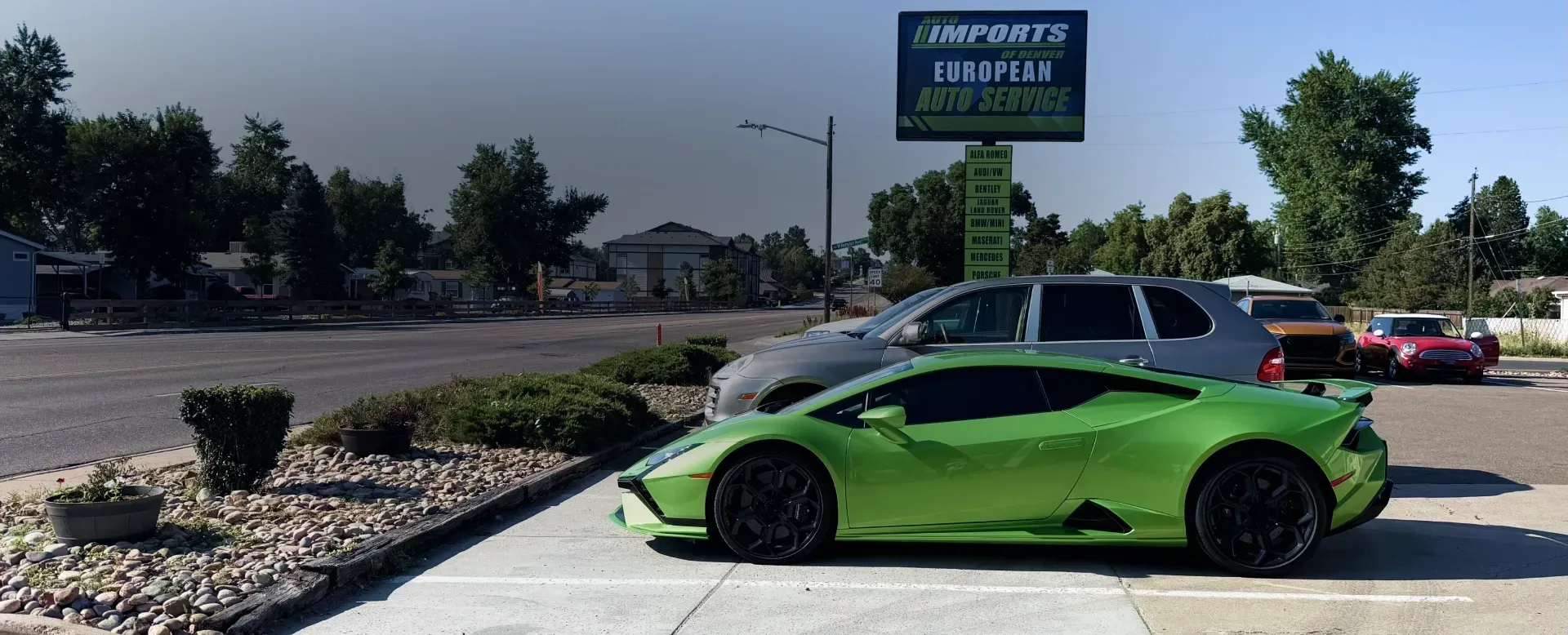Green car parked outside of our shop at Englewood, CO | AutoImports of Denver