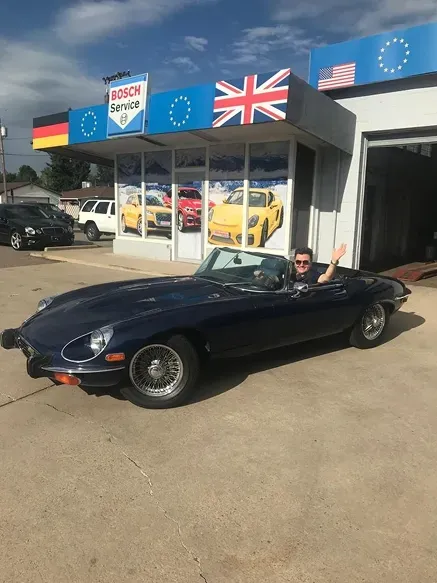 Front of our shop with black car | AutoImports of Denver