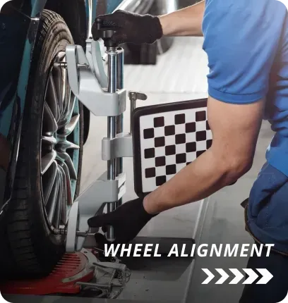 Man performing wheel alignments service on vehicle | AutoImports of Denver