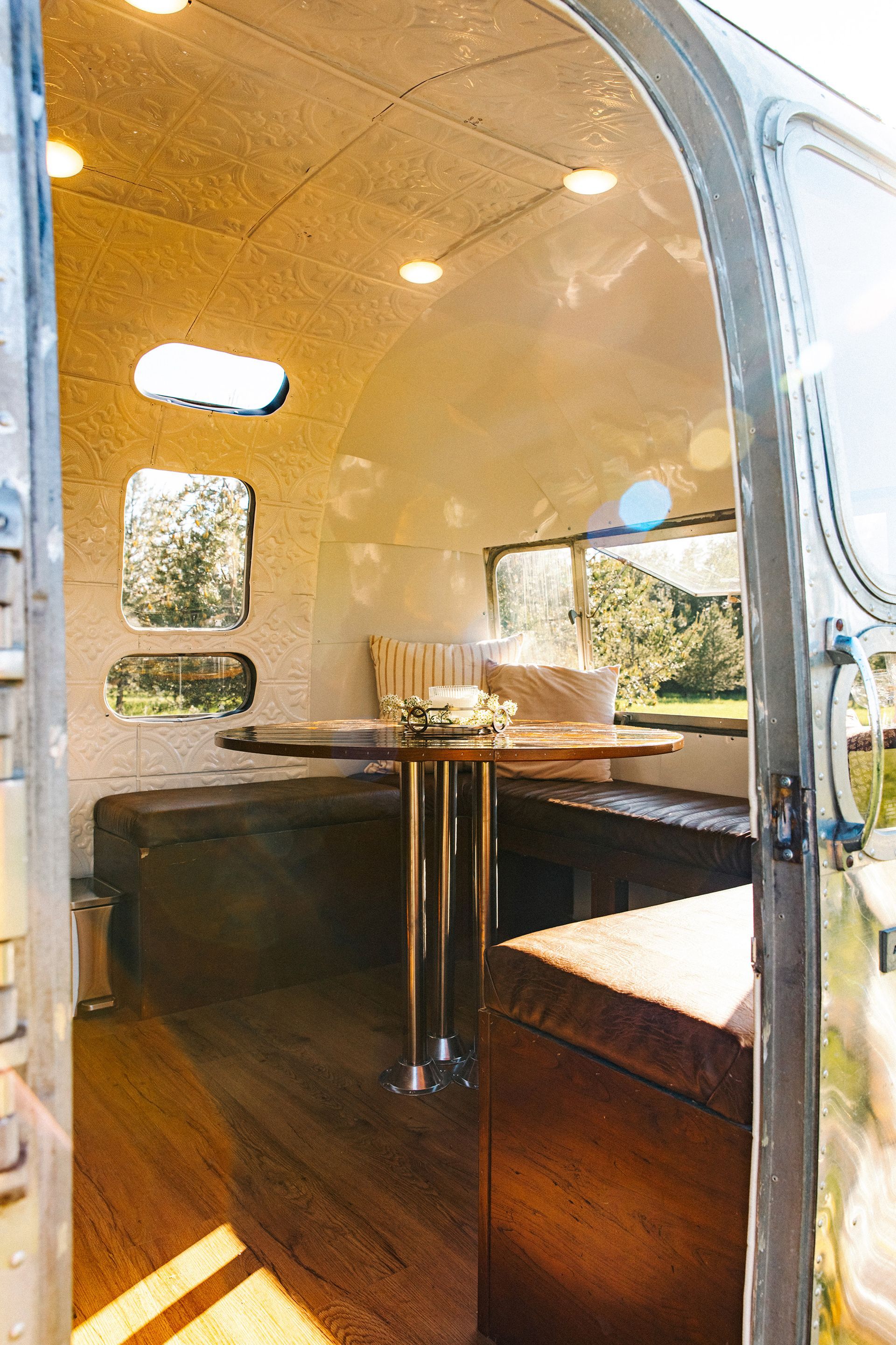 The inside of an airstream with a table and chairs