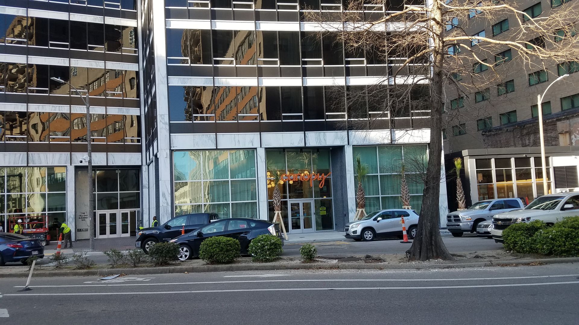 A building with a lot of windows and cars parked in front of it