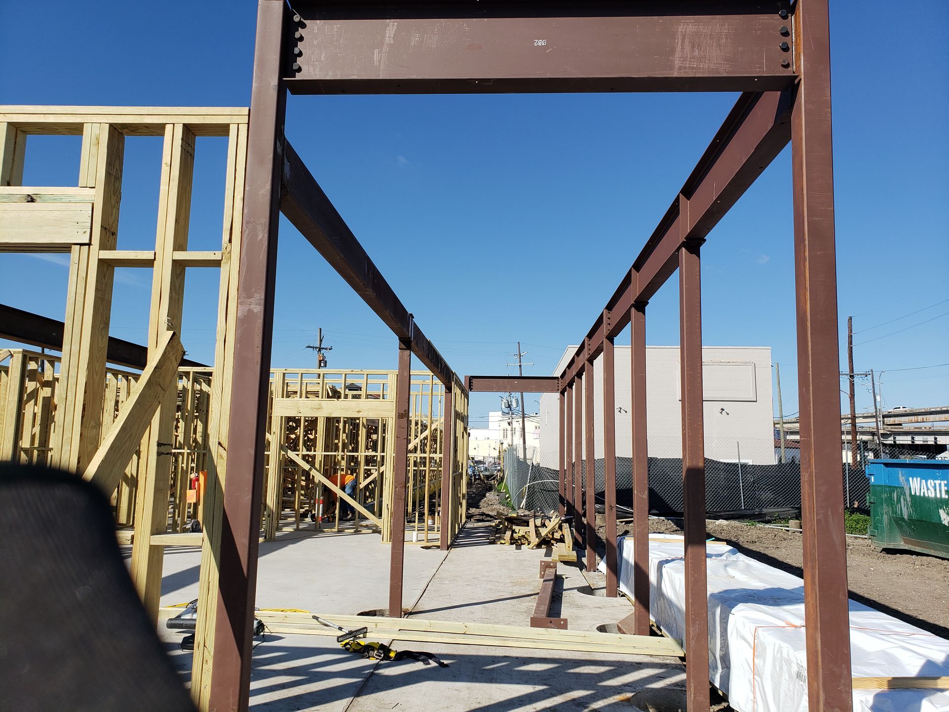 A large metal structure is being built on a construction site