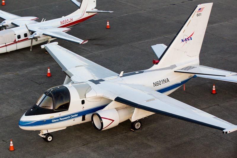 A nasa plane is parked next to another plane