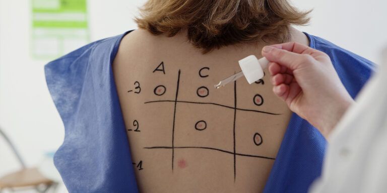 A woman testing a skin cream in a pharmacy
