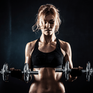A woman is lifting dumbbells in a gym.