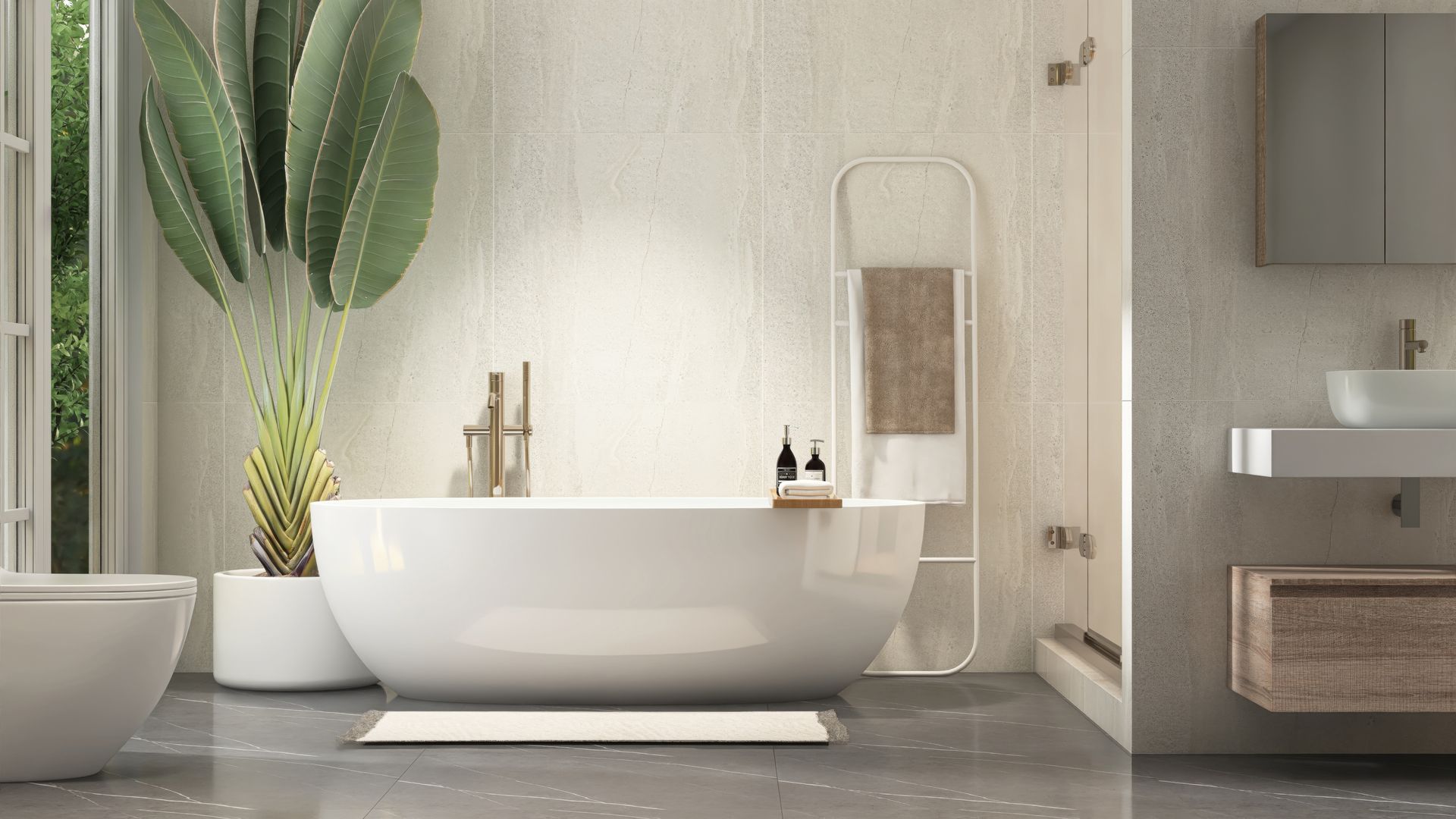 Modern bathroom with a white freestanding tub, potted plant, and gray vanity cabinet