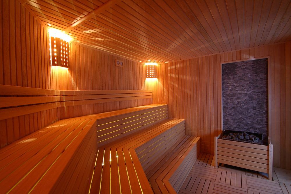 A Wooden Sauna With a Bench and Lights on the Walls — Intouch Pools & Spas in Nabiac, NSW