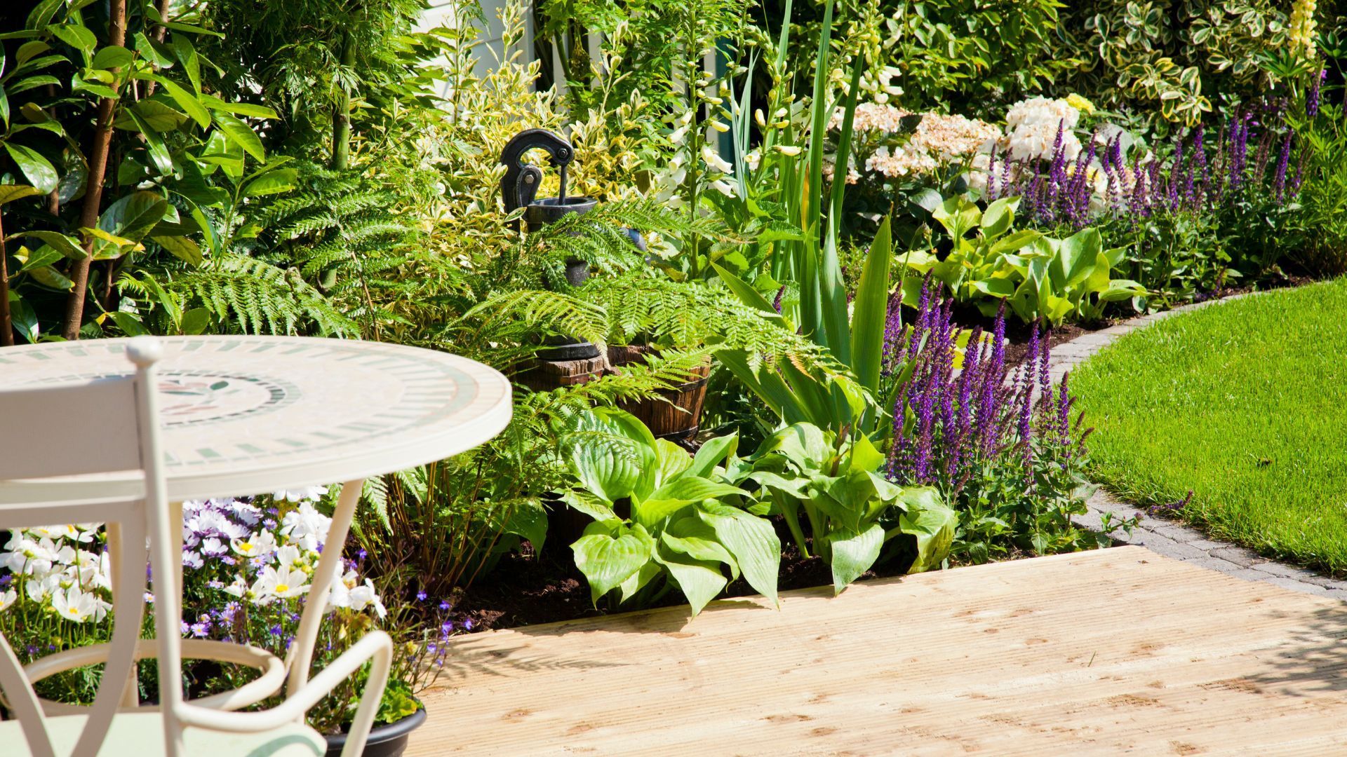 Charming garden patio with lush plants and a tiled table in Tempe, AZ.