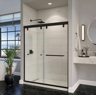 Black-framed sliding shower door in a modern bathroom with white tile walls, a black floor, and a nearby window.