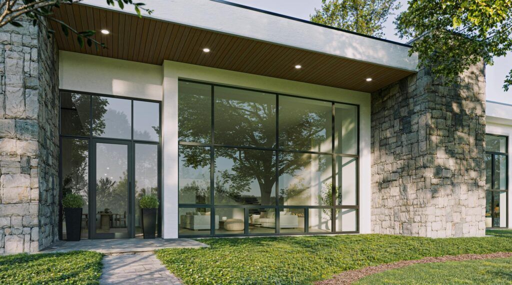 Modern building with stone accents, large glass windows, and a tree visible through them.