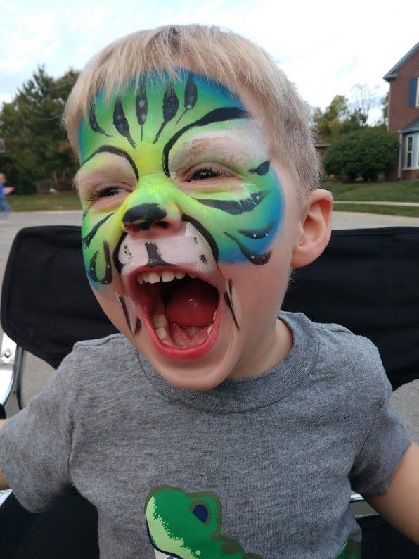 a boy with a tiger face painting