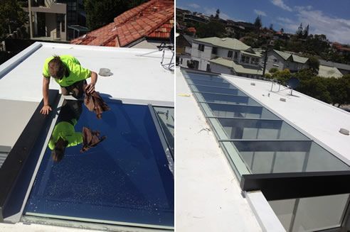 A Man Is Working On The Roof Of A Building — Home Tint Sunshine Coast Window Tinting In Maroochydore, QLD