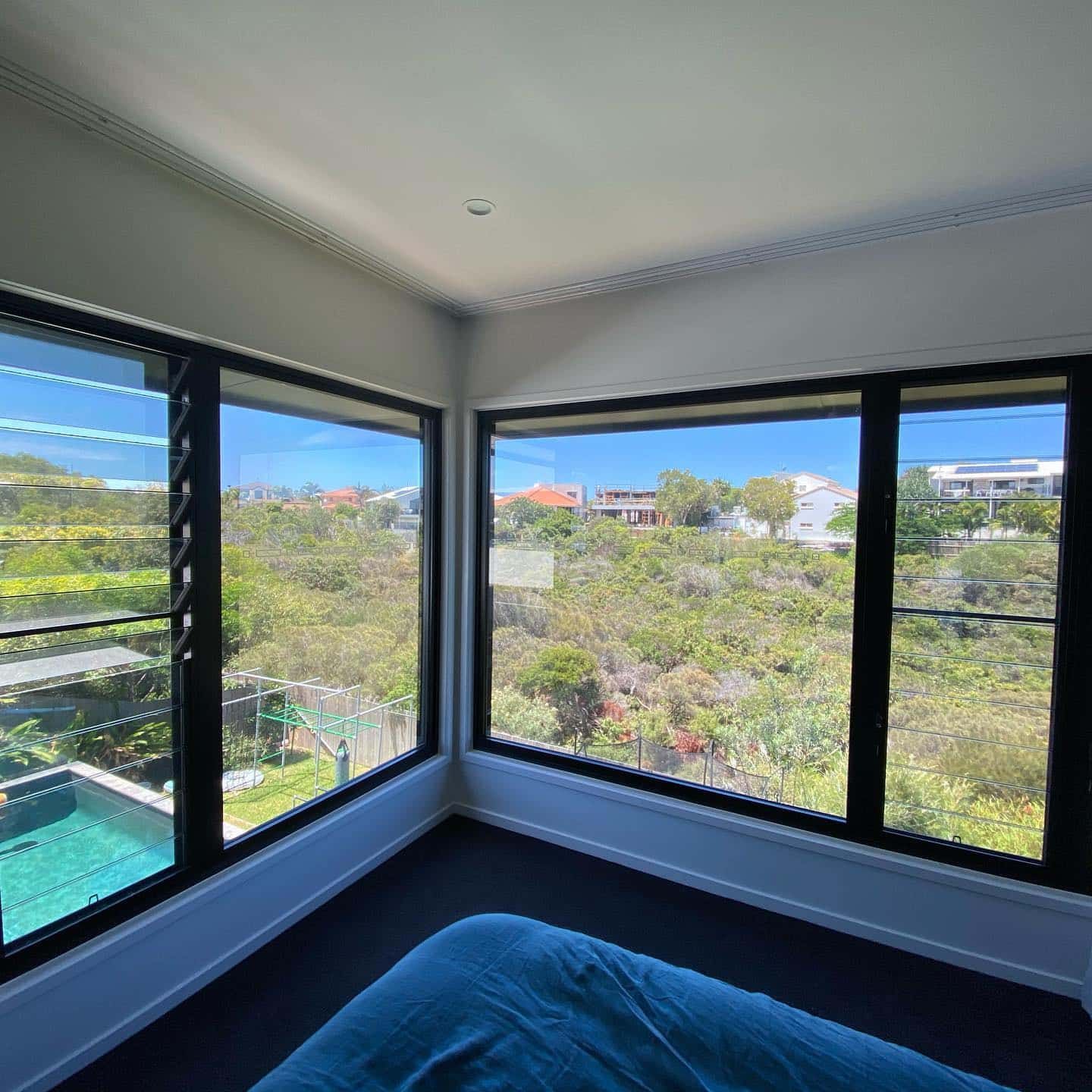 A Bedroom With A Lot Of Windows And A Bed — Home Tint Sunshine Coast Window Tinting In Maroochydore, QLD
