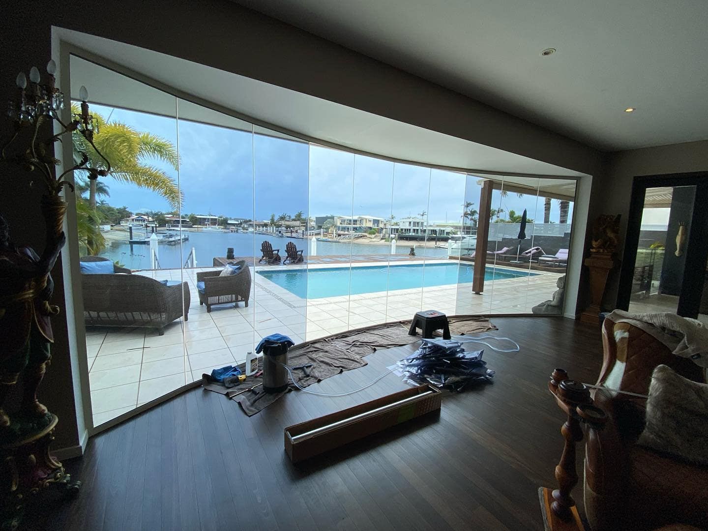 A Living Room With A Large Window Overlooking A Swimming Pool — Home Tint Sunshine Coast Window Tinting In Maroochydore, QLD