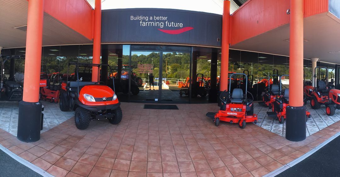 A Row Of Lawn Mowers Are Parked In Front Of A Building — Home Tint Sunshine Coast Window Tinting In Noosa, QLD