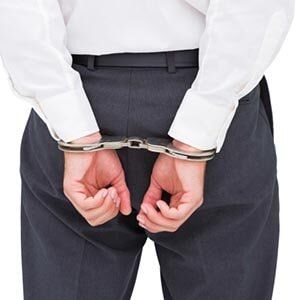 Defense  — Close Up on Young Businessman Wearing Handcuffs in York, PA