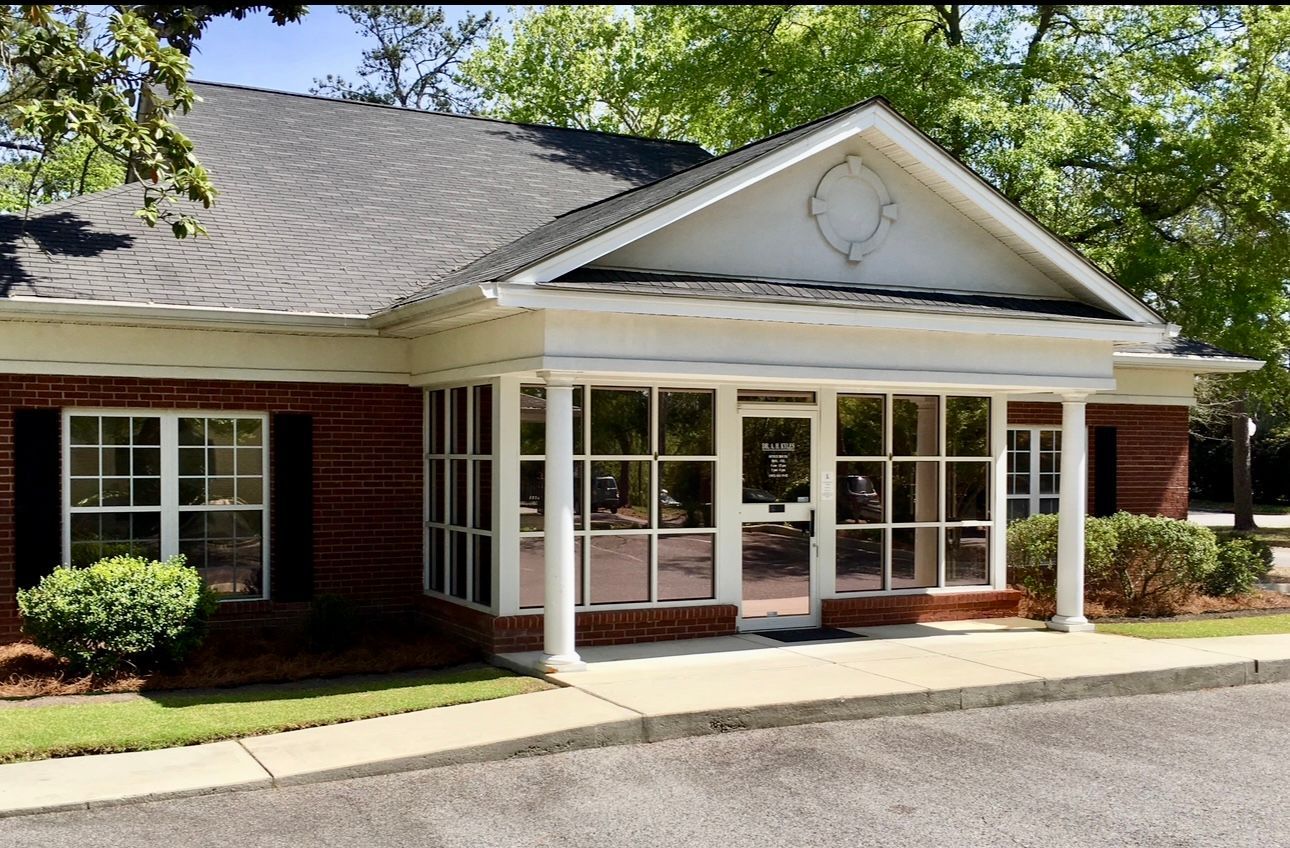 A professional performing a neck adjustment on a person in a clinical setting.