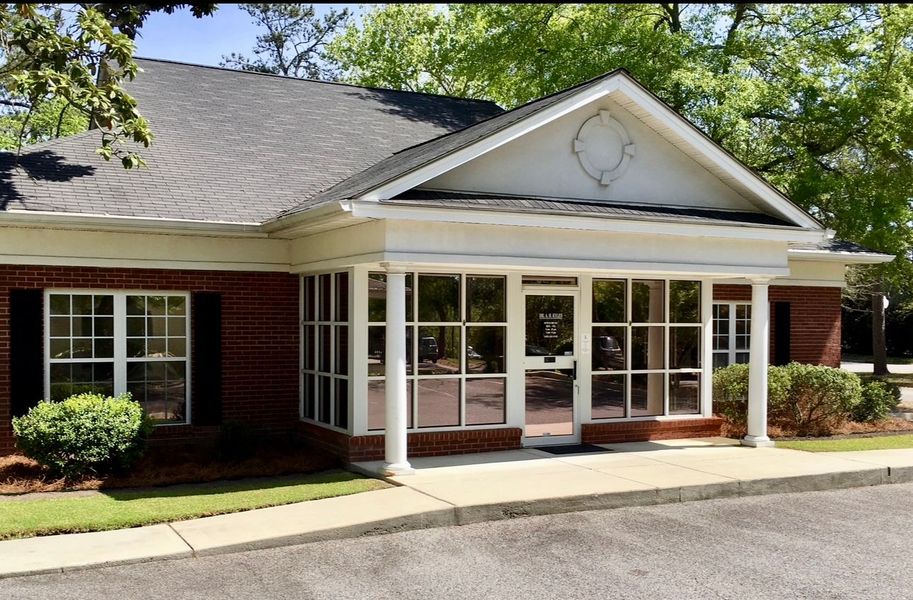 A professional performing a neck adjustment on a person in a clinical setting.