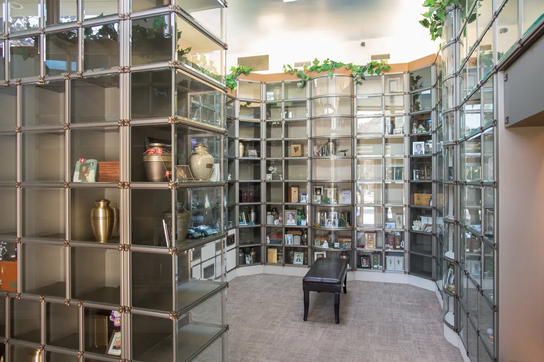 Modern room with tall open shelving, small display objects, and a single chair centered on a carpeted floor