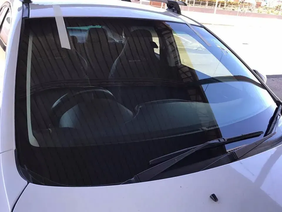 A White Car With A Wiper On The Windshield — Petrena Windscreens In Toowoomba City, QLD