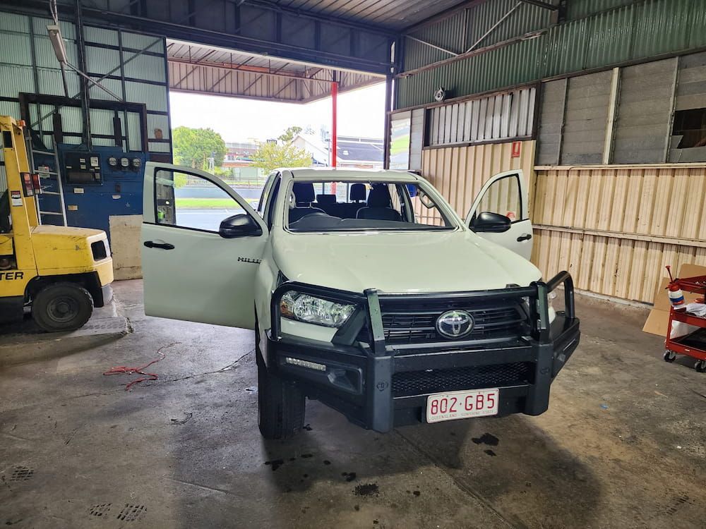 A White Truck Is Parked In A Garage With Its Doors Open — Petrena Windscreens In Clifton, QLD