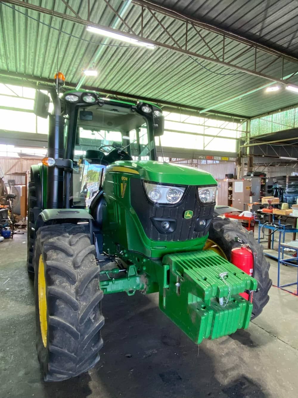 A Green John Deere Tractor Is Parked In A Garage — Petrena Windscreens In Leyburn, QLD