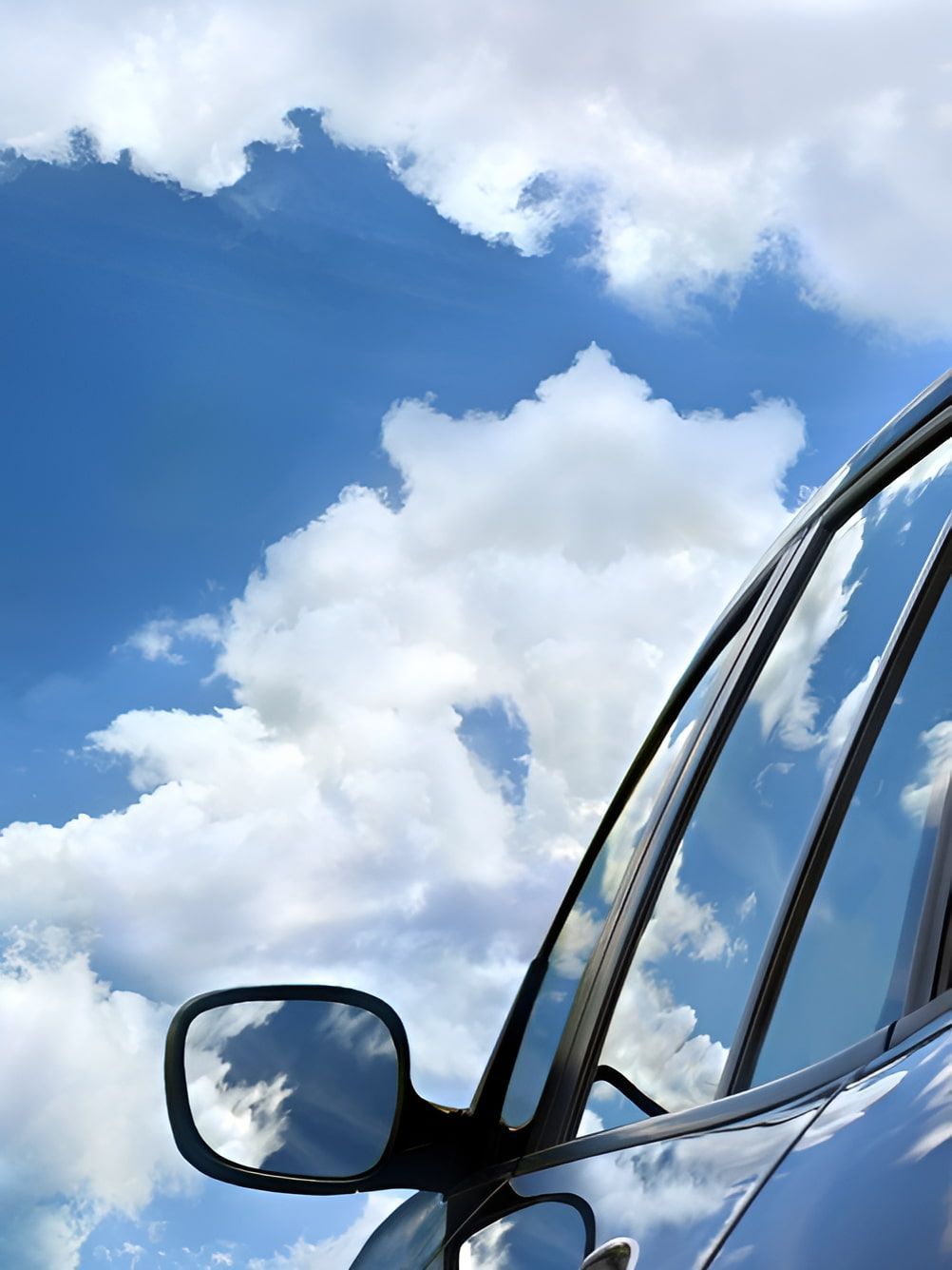 A Car Is Parked In Front Of A Blue Sky With Clouds — Petrena Windscreens In Leyburn, QLD