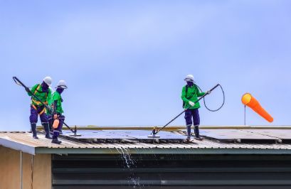 Roof painters preparing a residential roofing for painting in Townsville QLD.