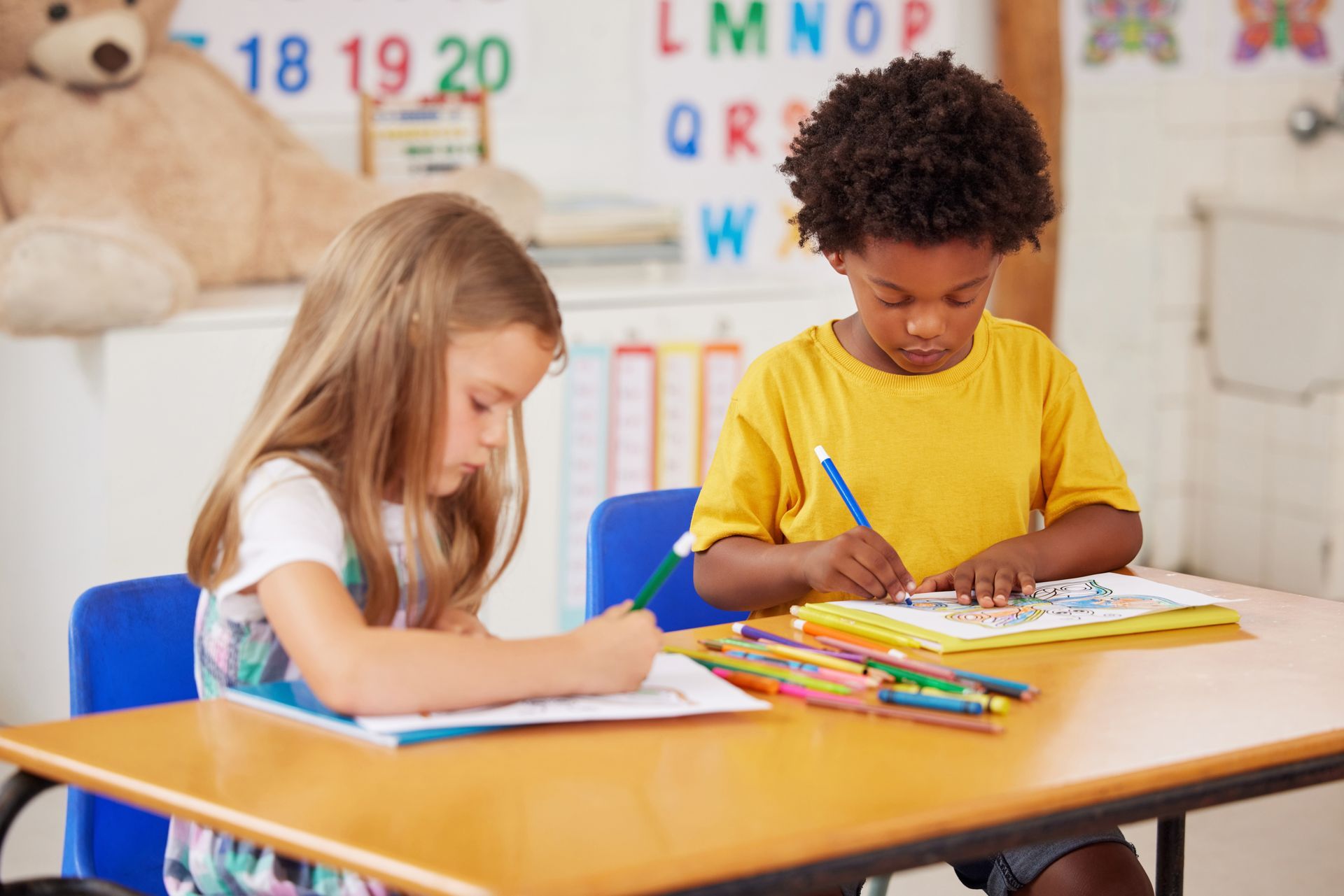 Two kids doing project together in school classroom