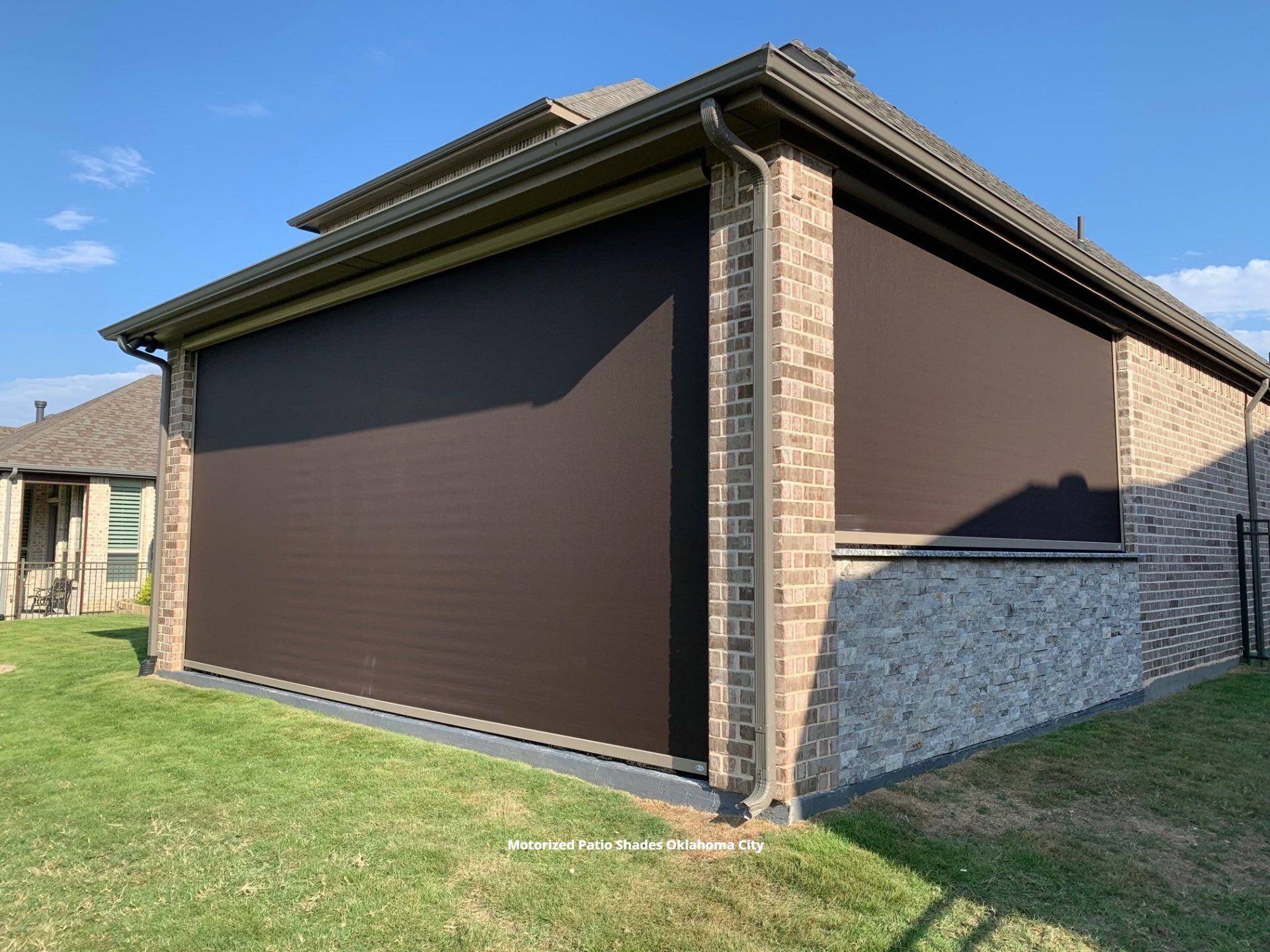 a picture of a house with a motorized screened in patio shaded oklahoma city