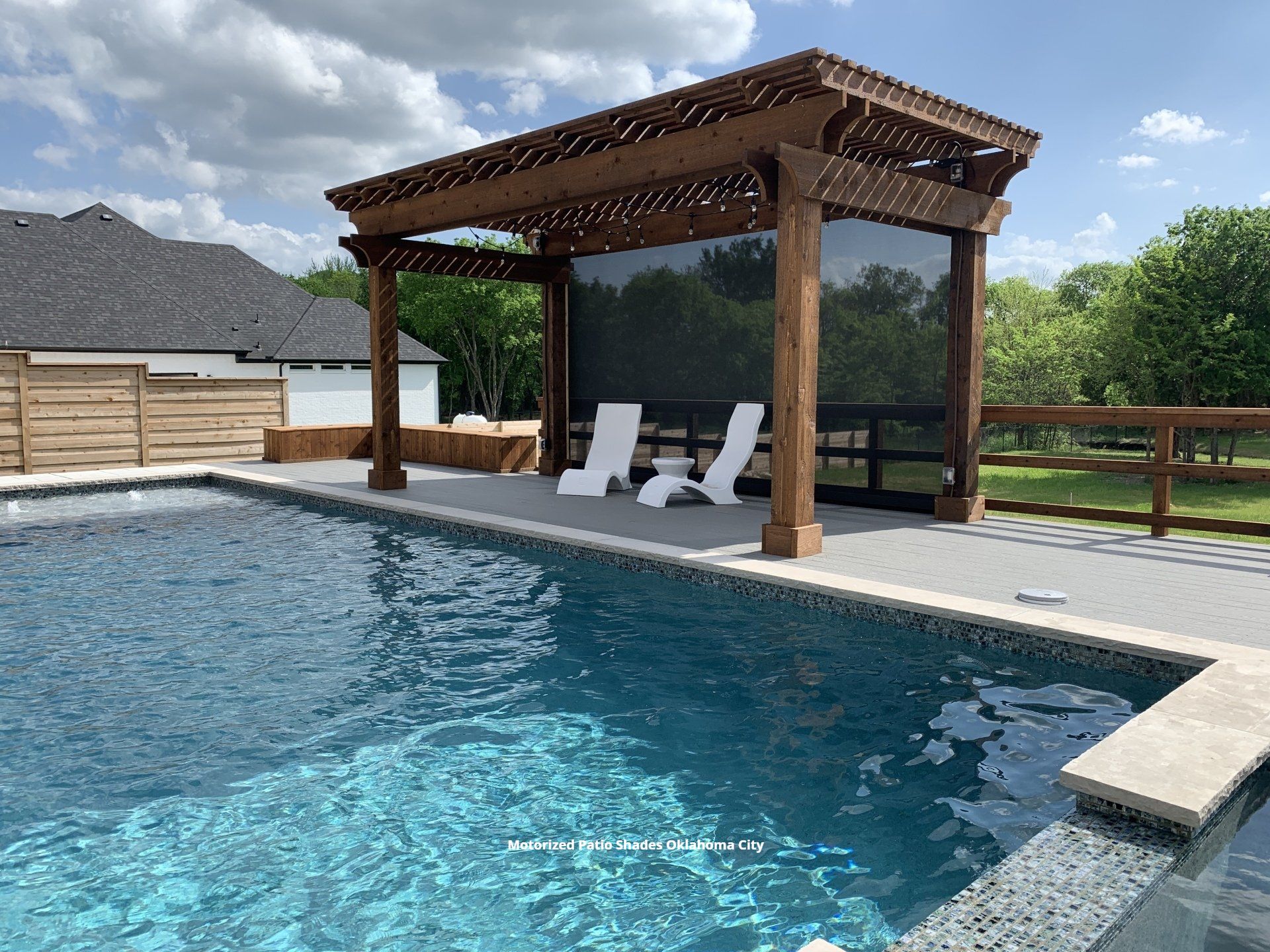 a swimming pool with a pergola and a motorized solar screen in oklahoma city