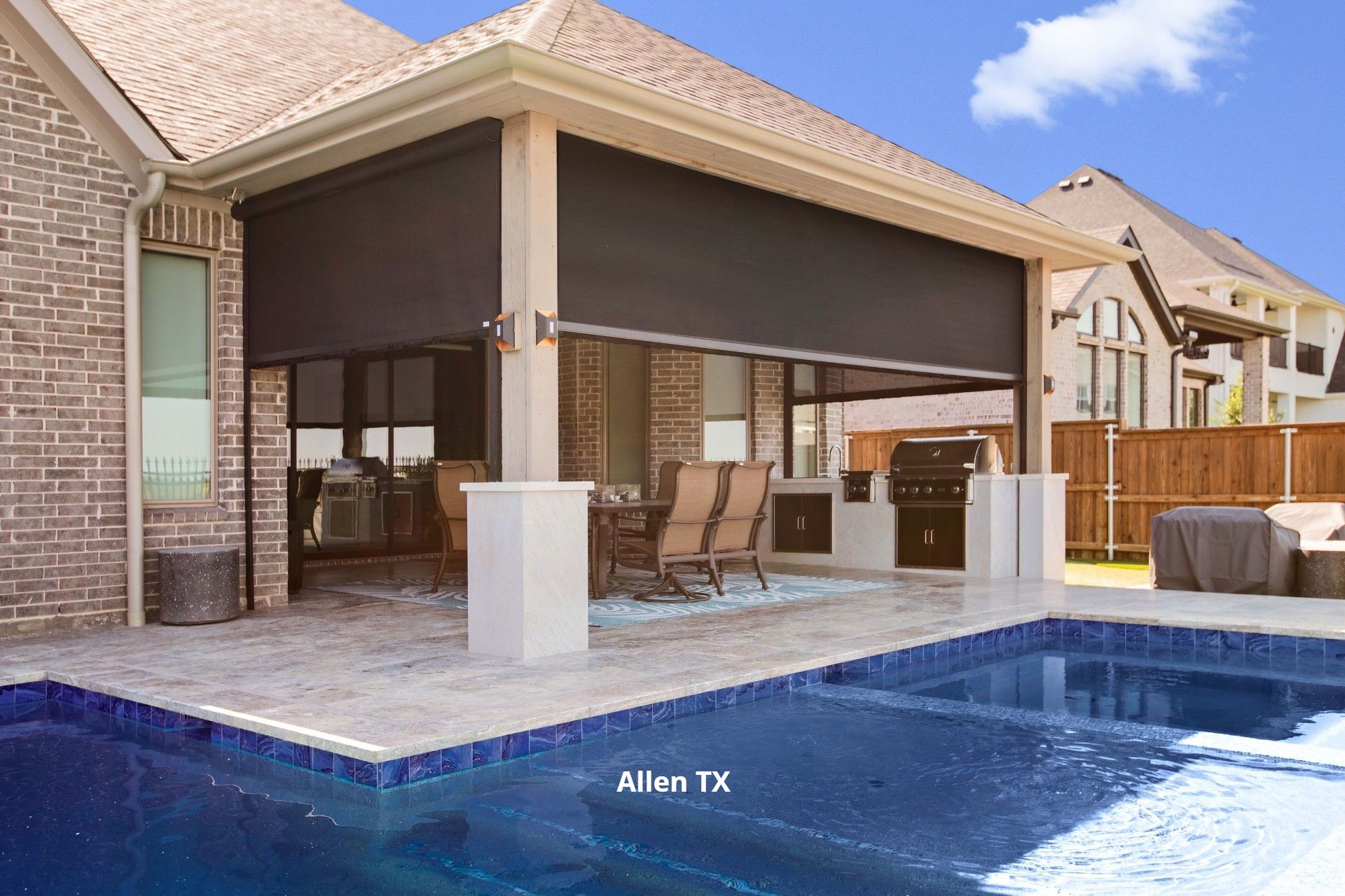 A motorized patio screen keeping the bugs at bay with a beatuiful outdoor dining table in Frisco TX