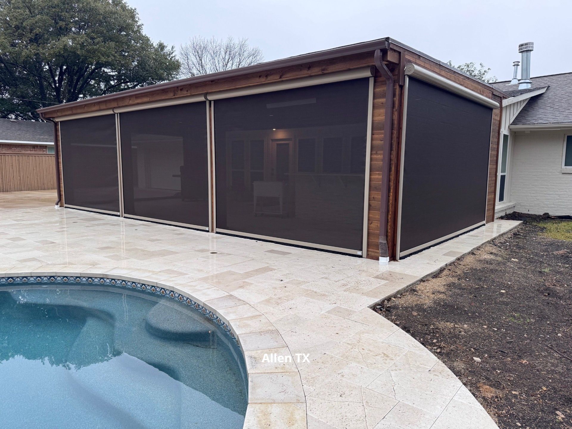 Motorized Patio Shade fully lowered with a luxurious pool area in Frisco TX