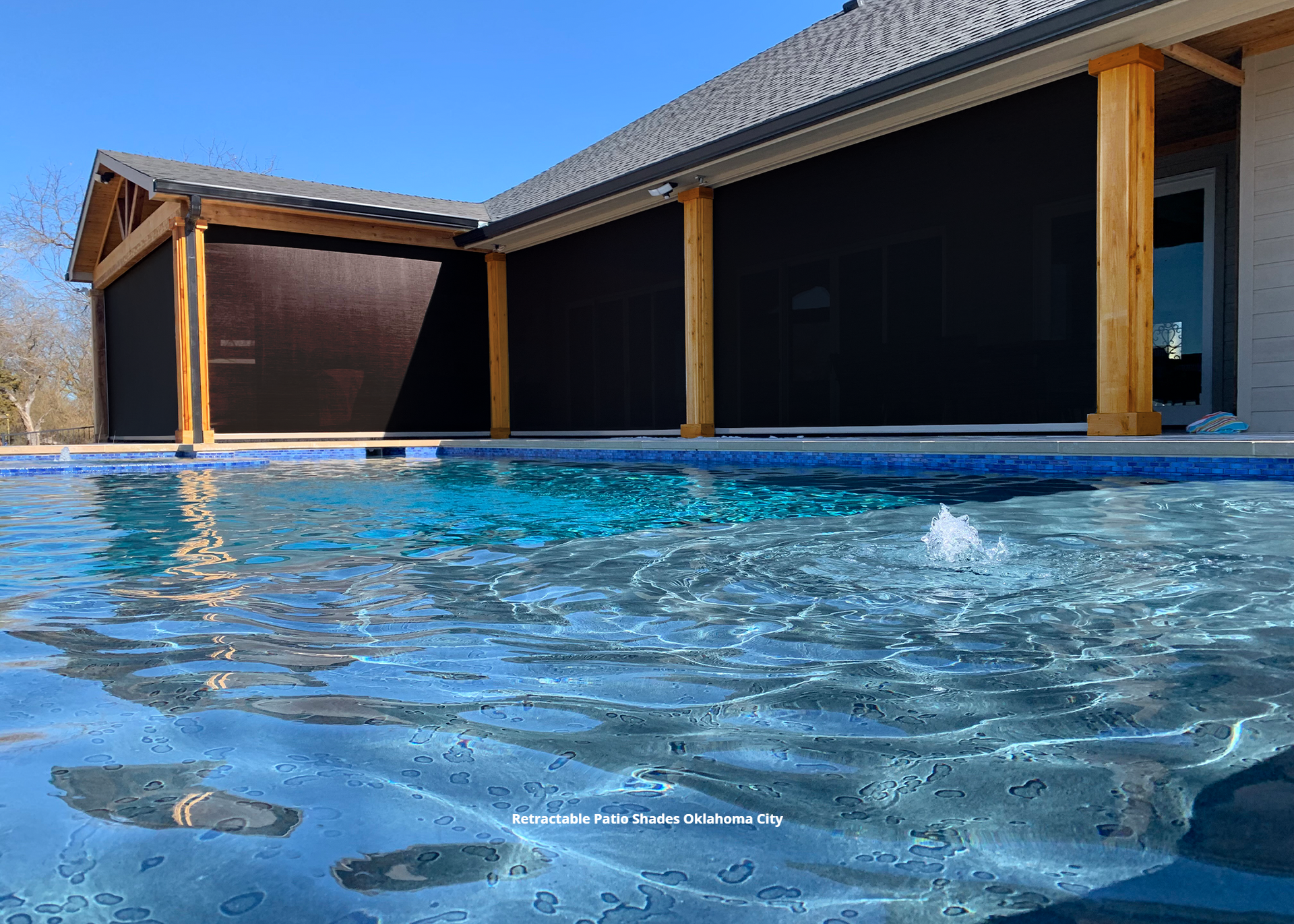 a swimming pool with retractable patio shades in oklahoma city
