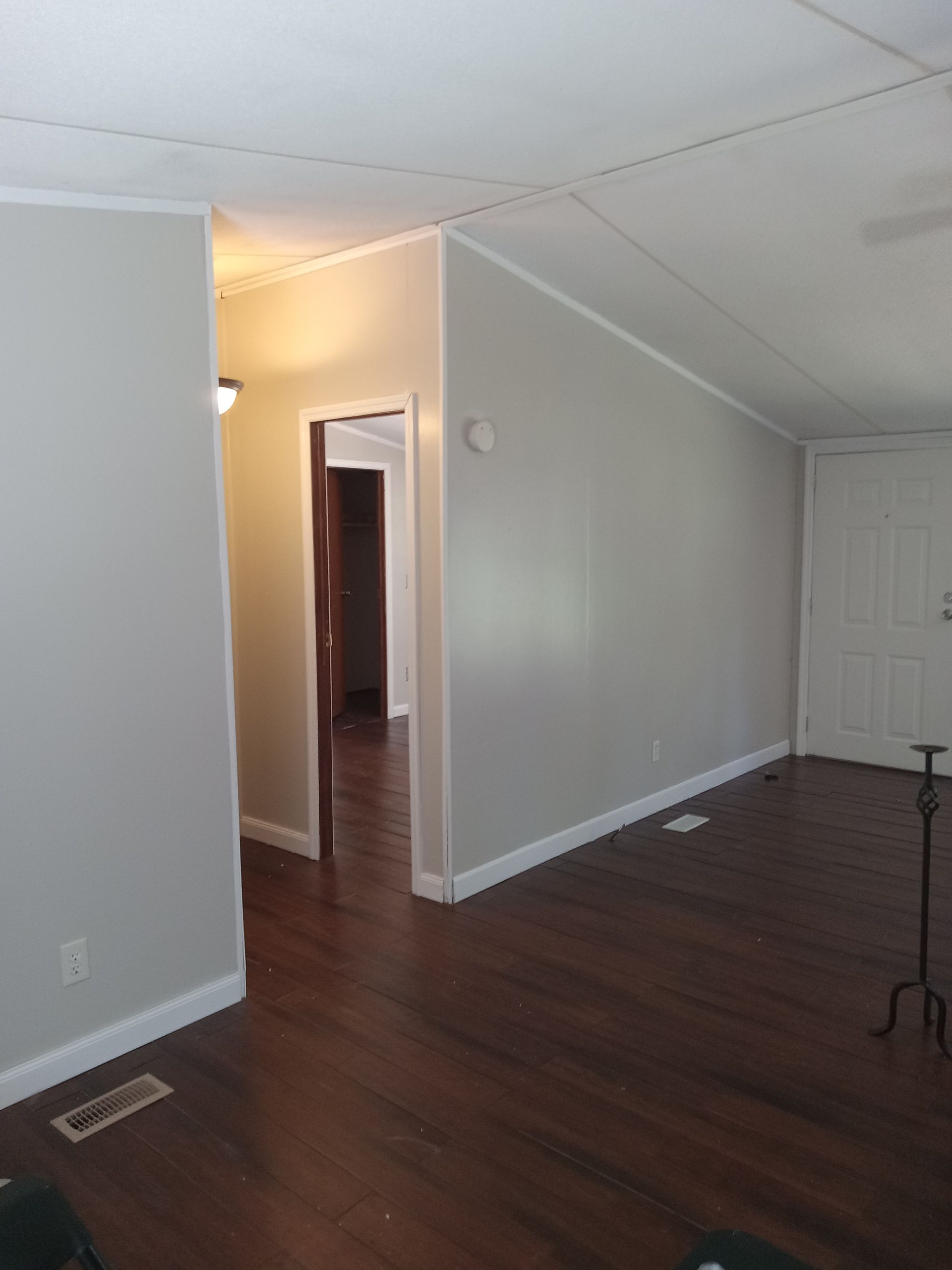 A living room with hardwood floors and white walls